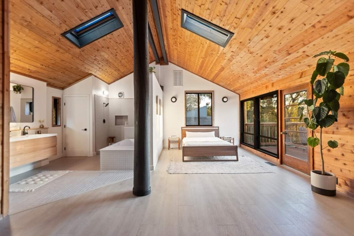 The home's open floor concept integrates the primary bedroom and bathroom with a sitting area.