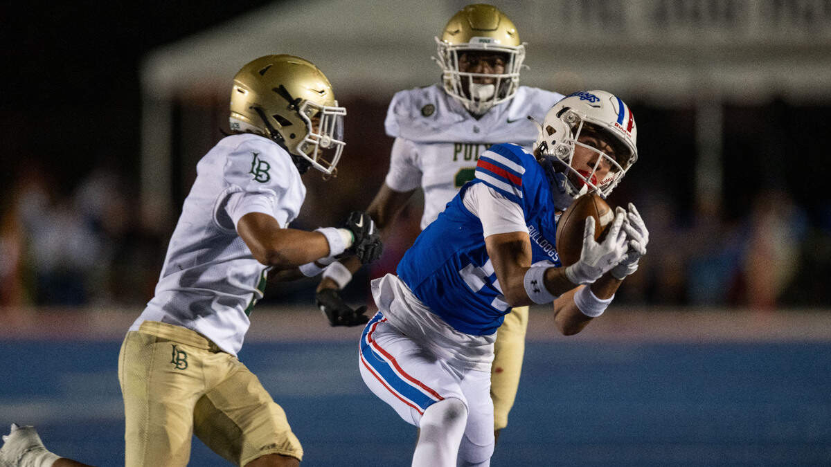 Folsom Bulldogs’ Rob Larson (14) catches a long pass in the third quarter against the Long Beach Poly Jackrabbits in 2024. 