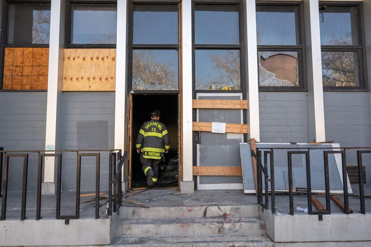A Sacramento firefighter walks into a vacant office building at 19th and J streets that burned Tuesday in midtown. A male, a female and a dog were found dead inside the building after an early morning fire.