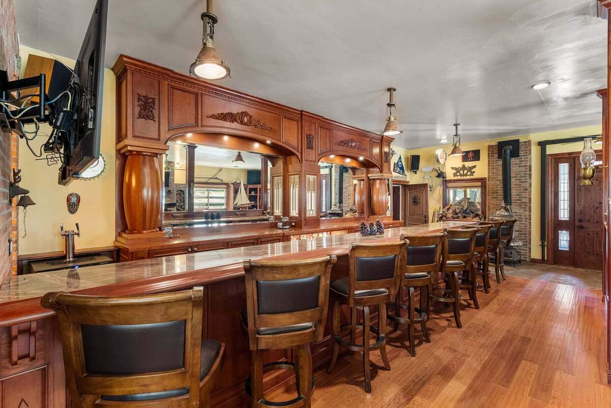 The estate’s centerpiece is a custom-built saloon that functions as a private entertainment space.