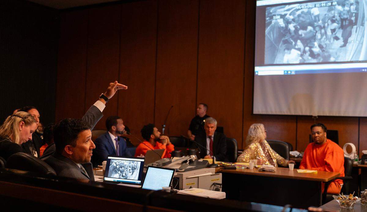 Prosecutor Brad Ng, left, questions a cousin of mass shooting victim Sergio Harris during a preliminary hearing in Sacramento Superior Court on Tuesday, April 4, 2024, in the case of the April 2022 mass shooting in downtown Sacramento. Ng’s questions involved video evidence depicting events from the night of the shooting that was projected in the courtroom.