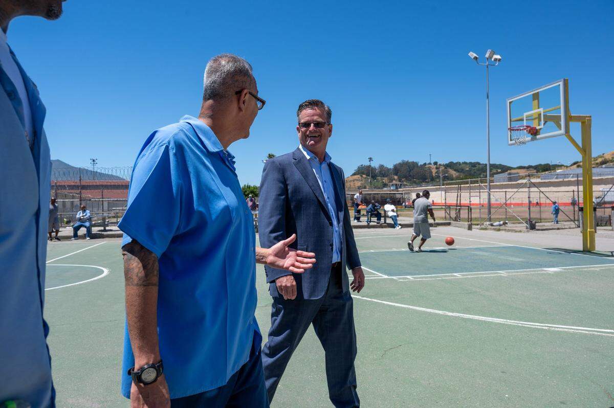 Warden Ron Broomfield walks the yard and talks with inmates at San Quentin State Prison in San Rafael on Wednesday, July 26, 2023. In March 2023, Gov. Newsom announced a plan to transform the prison into the San Quentin Rehabilitation Center. The transformation is being guided by a team of correctional, reentry and rehabilitation experts.