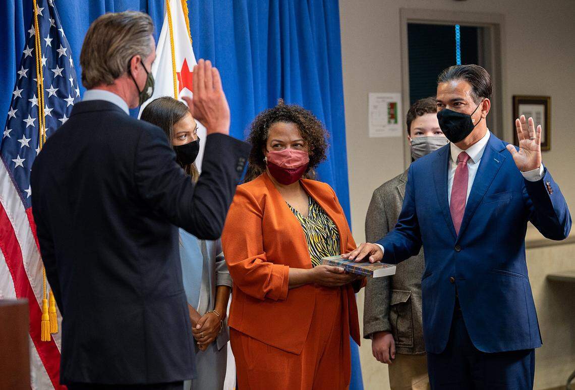 Now-Assemblywoman Mia Bonta, D-Oakland, stands alongside her husband, Attorney General Rob Bonta, as Gov. Gavin Newsom swears him in during a ceremony in April 2021. Mia Bonta shared her abortion story at a news conference highlighting the impacts people of color will face if the U.S. Supreme Court strikes down Roe v. Wade. She said the attorney general “held (her) hand” when she made the decision to have an abortion as she finished college.