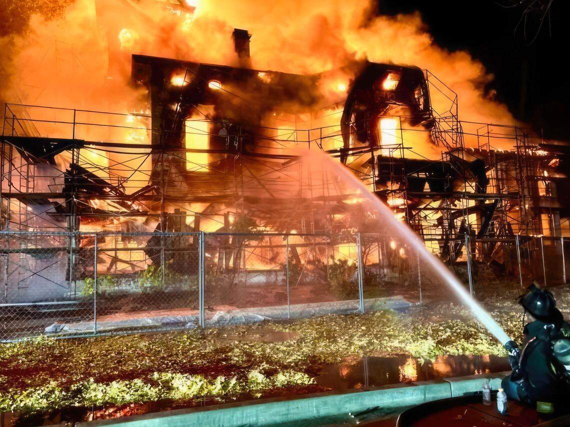 Firefighters attempt to extinguish a blaze at the Bidwell Mansion, a California State Historic Park building in Chico, before dawn on Wednesday, Dec. 11, 2024.