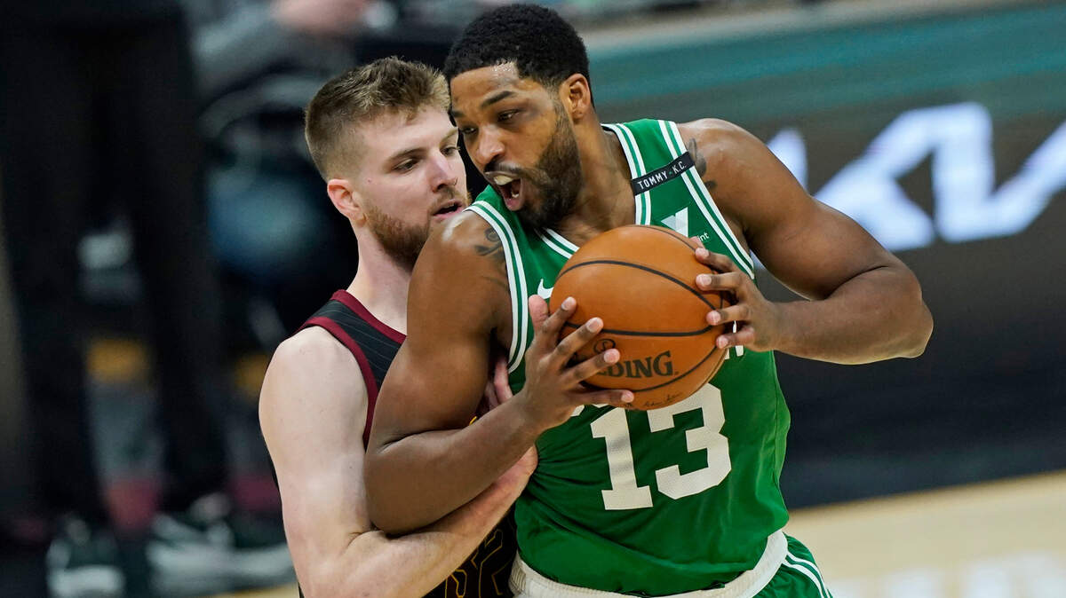 Boston Celtics’ Tristan Thompson, right, drives against Cleveland Cavaliers’ Dean Wade during the first half of an NBA basketball game Wednesday, May 12, 2021, in Cleveland. (AP Photo/Tony Dejak)