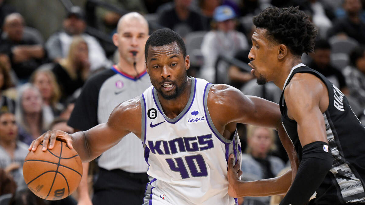Sacramento Kings’ Harrison Barnes (40) drives against San Antonio Spurs’ Josh Richardson, right, during the first half of an NBA basketball game, Sunday, Jan. 15, 2023, in San Antonio. (AP Photo/Darren Abate)