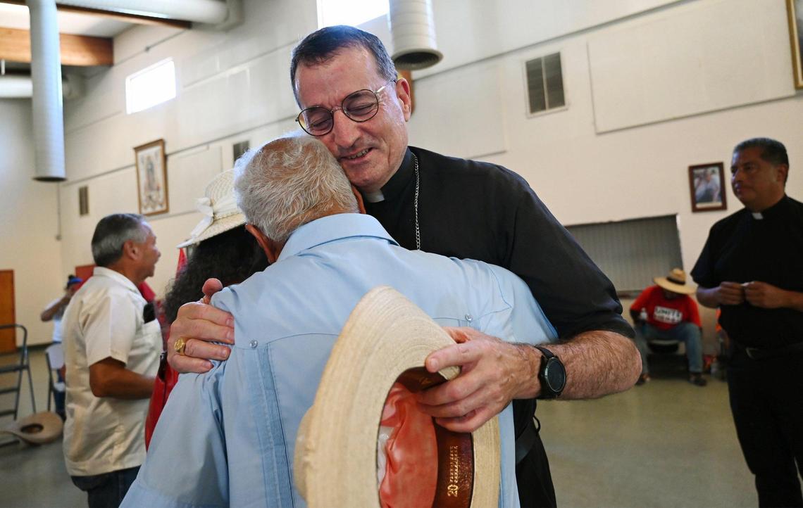 Catholic Bishop Joseph V. Brennan greets UFW founder Cesar Chavez’ son Paul Chavez as the marchers in the UFW’s March For The Governor’s Signature rest from the heat in a Catholic Church on Aug. 11, south of Fresno.