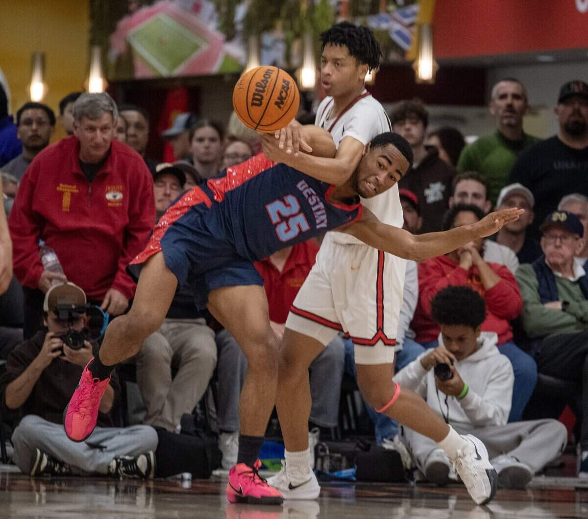The Jesuit Marauders' Maison Phillips (5) and the Destiny Christian Lions’ Myles Wiggins (25) battle for a loose ball in the first half of the CIF Division II Boys NorCal Regional Final on March 11, 2025 in Carmichael.