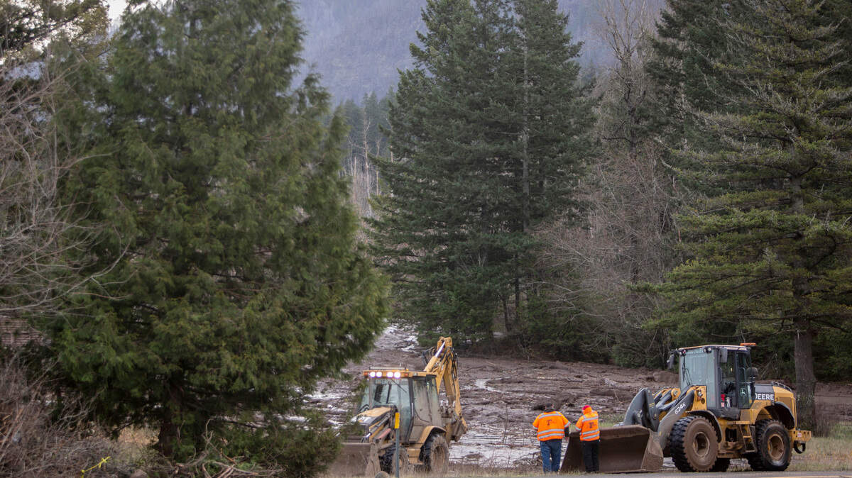Rescue crews search for a missing woman whose car was swept away by a landslide Jan. 13 in the Dodson area of the Columbia River Gorge. On Saturday, searchers recovered the body of Jennifer Moore, 50.
