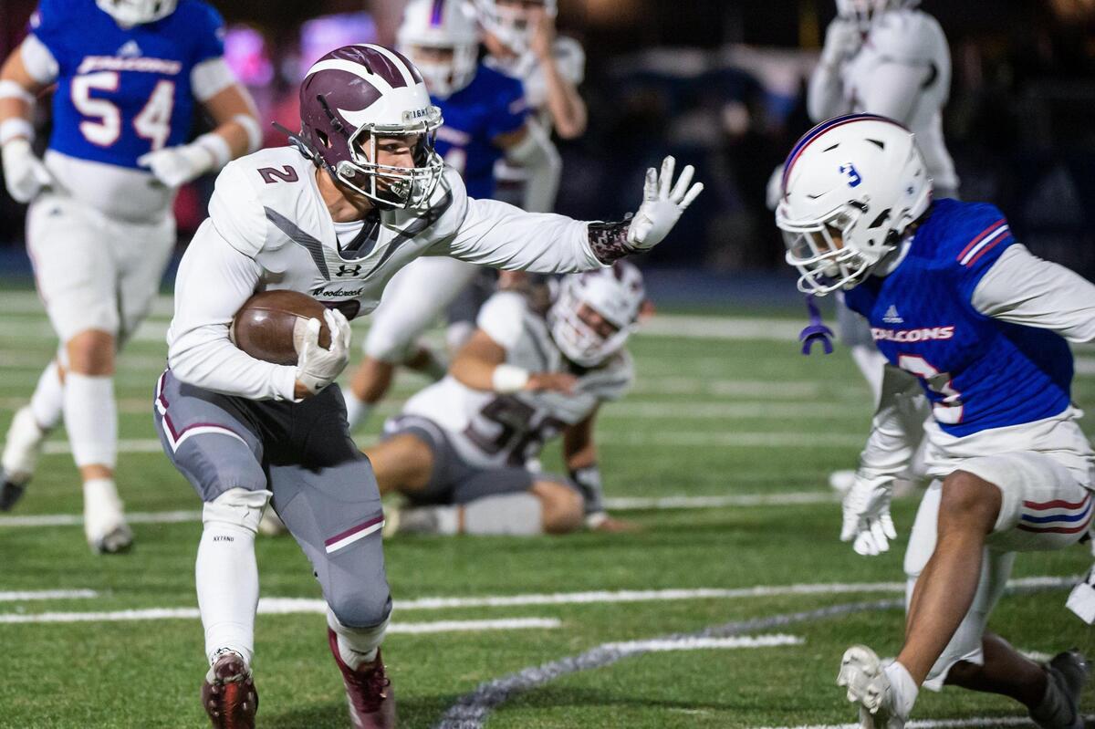 Woodcreek Timberwolves’ Brody Krupp (2) rushes for 18 yards before being tackled by Christian Brothers Falcons wide receiver Daniel Powers (3) during the first half in the CIF Sac-Joaquin Division III semifinals playoff game Friday at Christian Brothers High School.