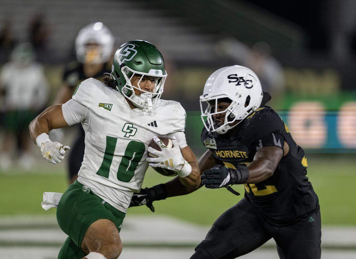 Cal Poly Mustangs wide receiver Michael Briscoe is tackled by Sacramento State Hornets linebacker Matthew Eskridge II after a catch in the second half on Sept. 27 in Sacramento.