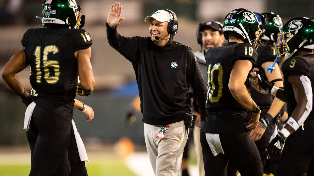 Sacramento State head coach Troy Taylor congratulates his players after a touchdown in the second quarter against Northern Arizona University during the Hornets’ homecoming NCAA football game Saturday, Oct. 23, 2021, at Hornet Stadium in Sacramento.