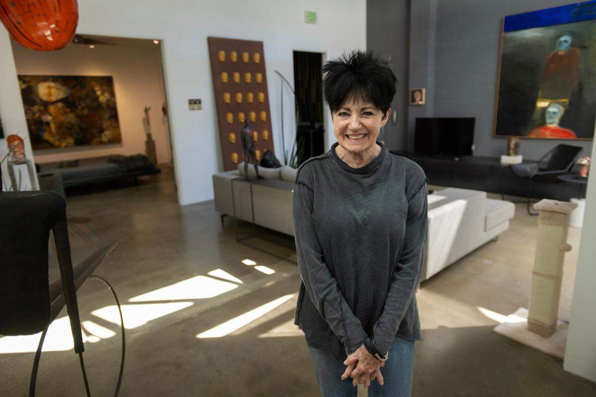 Sacramento art dealer Pamela Skinner stands Wednesday inside the former industrial space that she converted into living space home at 1225 D Street in Sacramento’s Mansion Flats neighborhood. Skinner has listed her home for $1.6 million.