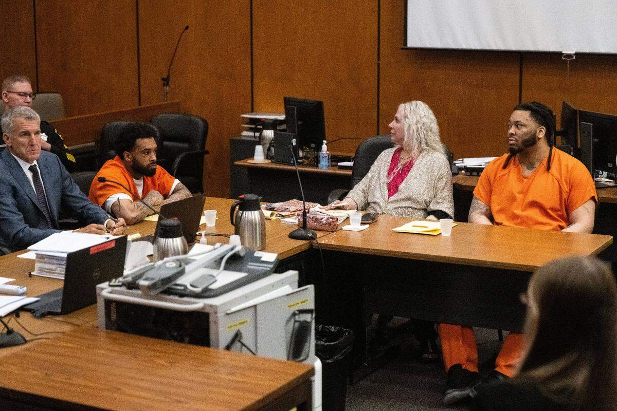 Defendant Dandrae Martin, right, and his attorney Linda Parisi look toward the gallery as people cry when the murder charges are dismissed against Smiley Martin, who died in jail in June, during a preliminary hearing in Sacramento Superior Court on Friday. Mtula Payton, who is also charged in the 2022 gang-related gun fight on K Street, sits at left.