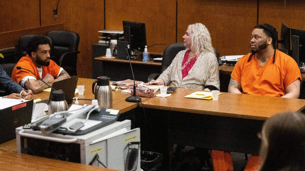 Defendant Dandrae Martin, right, and his attorney Linda Parisi look toward the gallery as people cry when the murder charges are dismissed against Smiley Martin, who died in jail in June, during a preliminary hearing in Sacramento Superior Court on Friday, Aug. 16, 2024. Mtula Payton, who is also charged in the 2022 gang-related gun fight on K Street, sits at left.