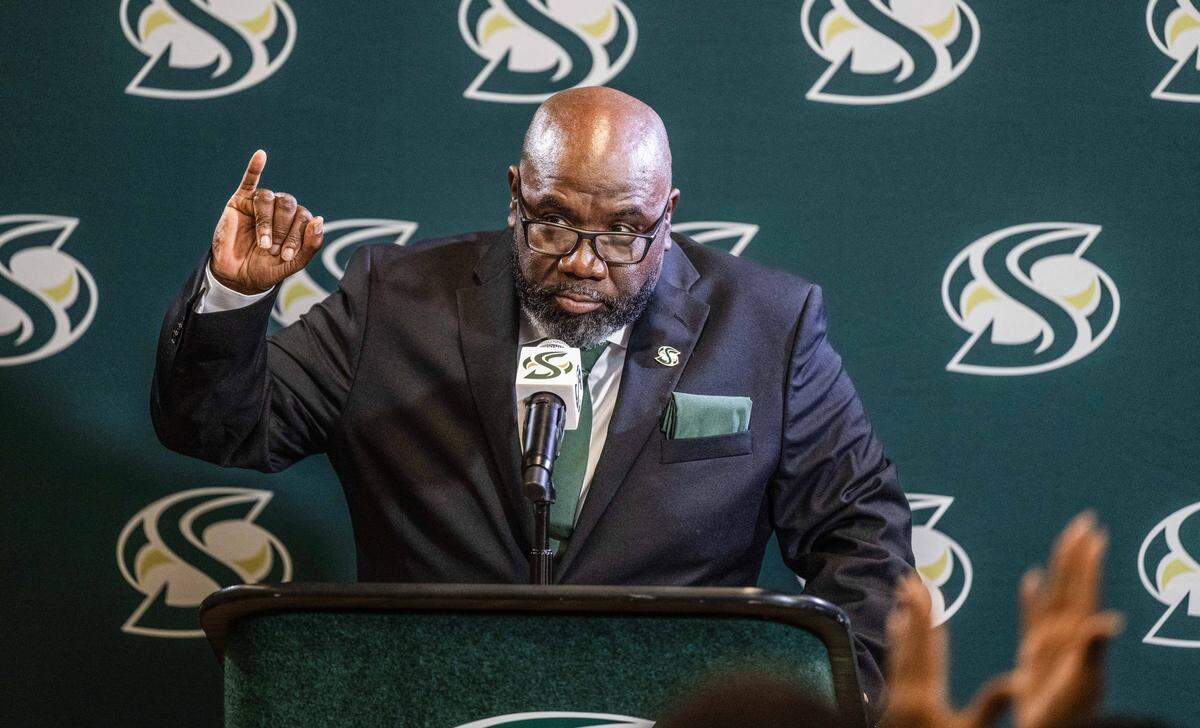 New Sacramento State football coach Alonzo Carter makes the “stingers up” gesture as he speaks during his introductory news conference on Thursday, Dec. 18. Carter added 12 players this week for 2026 during the second and final letter-of-intent signing period this winter.