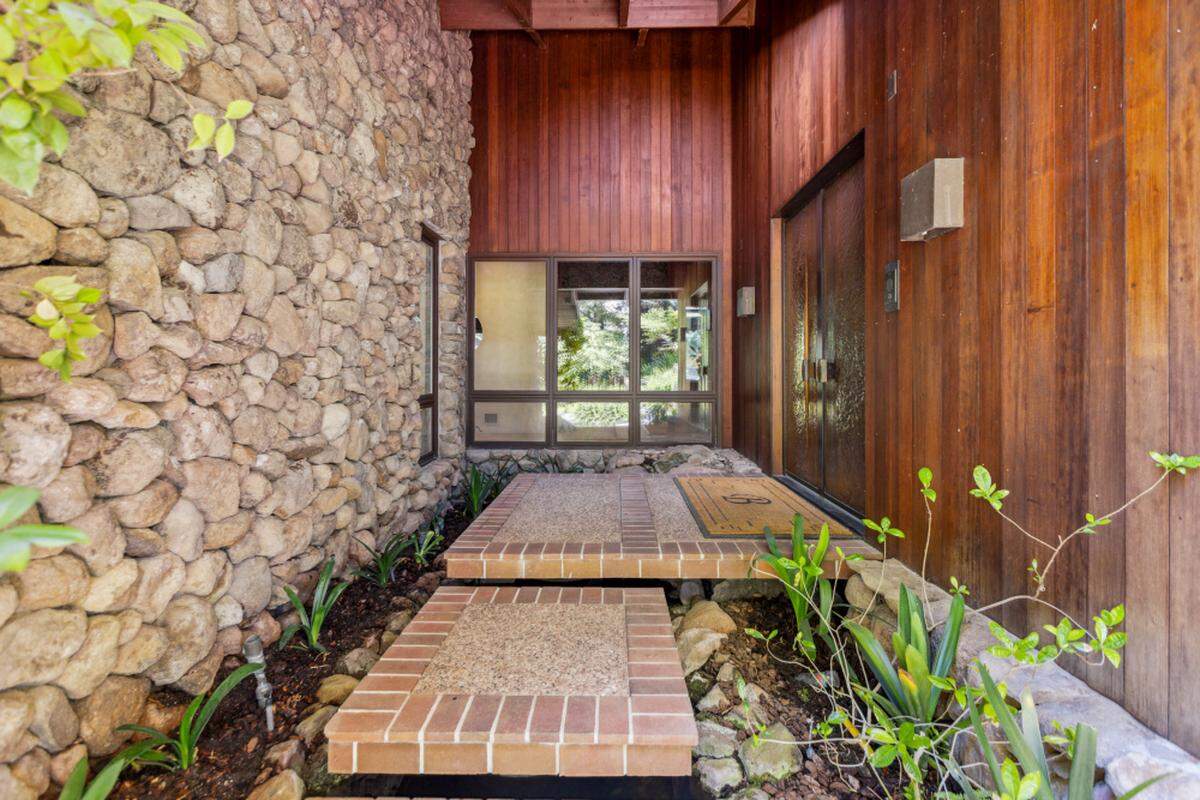 The entrance to the Carmichael, California, home sets the tone with a pathway over a koi pond.