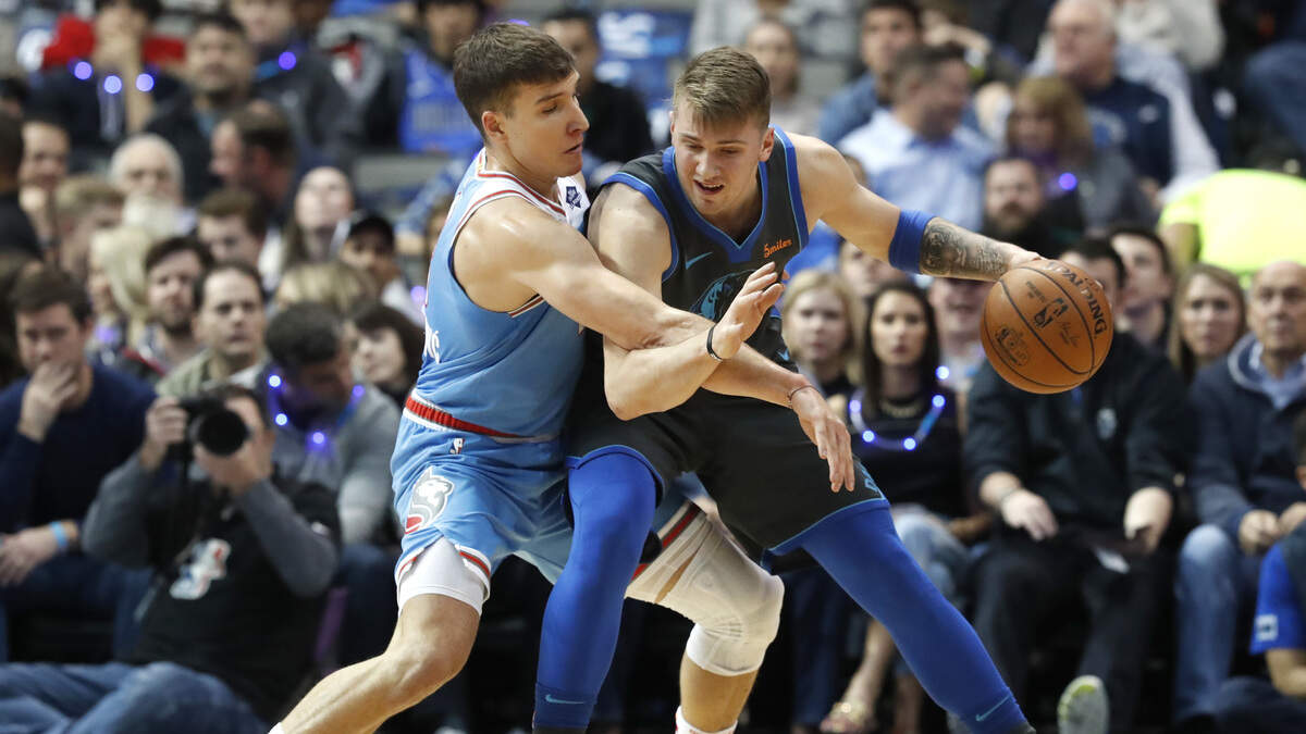 Kings guard Bogdan Bogdanovic, left, defends against Dallas Mavericks rookie forward Luka Doncic on Sunday in Dallas. The Kings won 120-113.