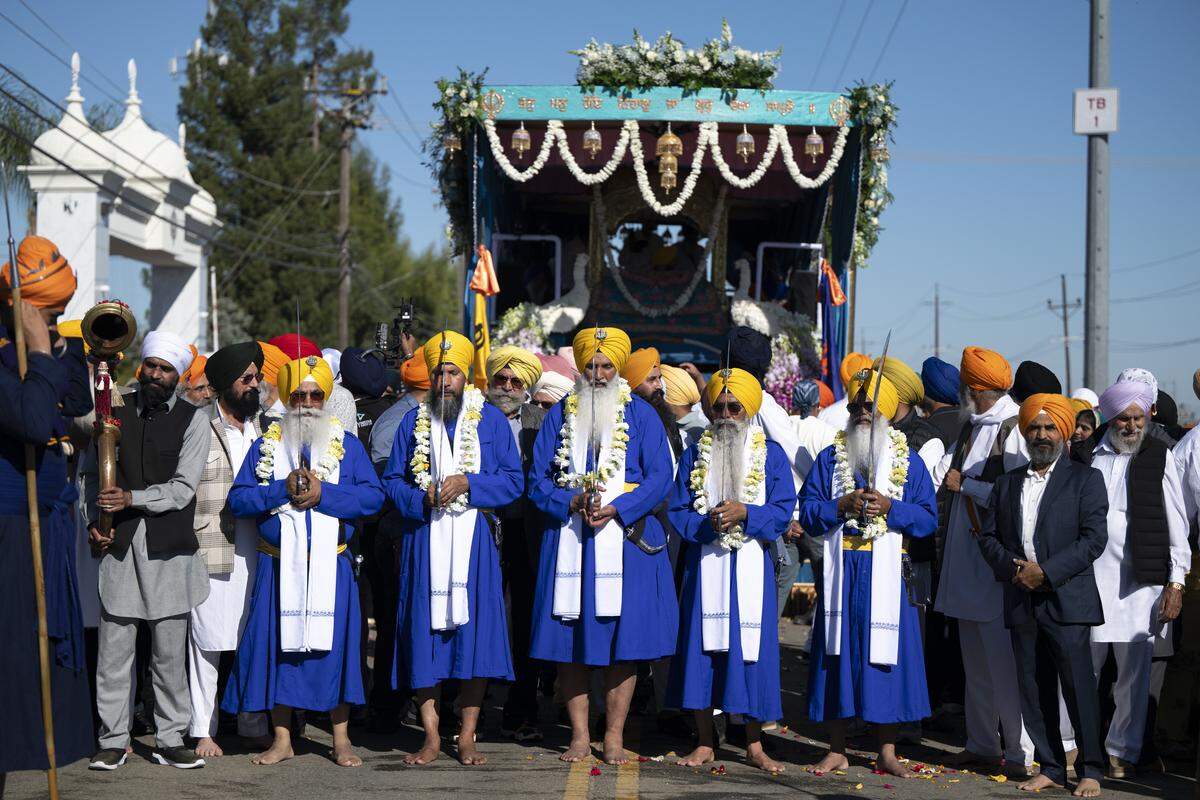 Members of the panj piayra protect the main float during Nagar Kirtan, also known as the Sikh Parade, in Sutter County on Sunday, Nov. 2, 2025.