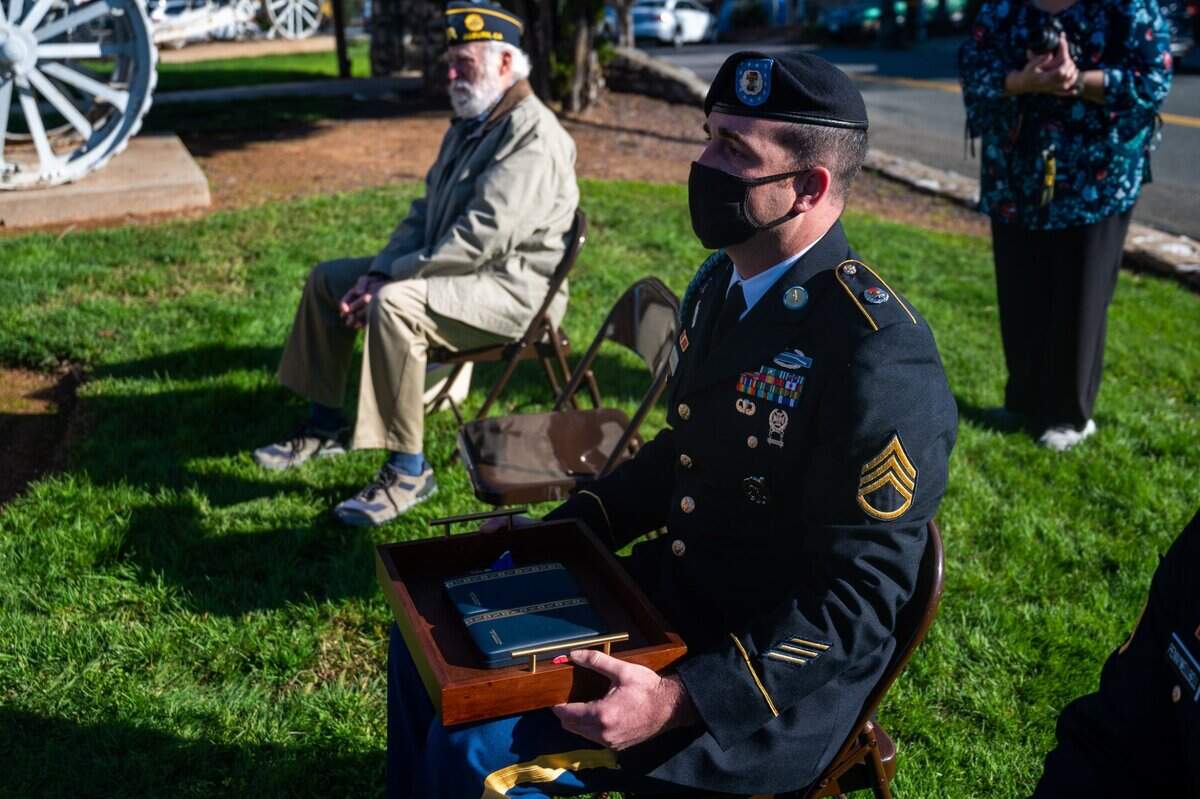 Staff Sgt. Ross Thompson holds the Bronze Star and a Purple Heart before they were awarded to Marvin D. Cornett at a ceremony in Auburn on Monday, Feb. 22, 2021, 77 years after he earned them.