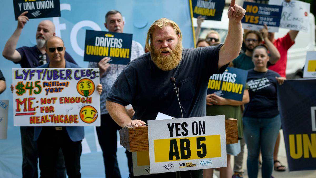 Uber driver and organizer Jeff Perry of Sacramento speaks in supporter of Assembly Bill 5 at the California state Capitol on Wednesday, Aug. 28, 2019. The bill would force “gig economy” employers to treat independent contractors as employees.