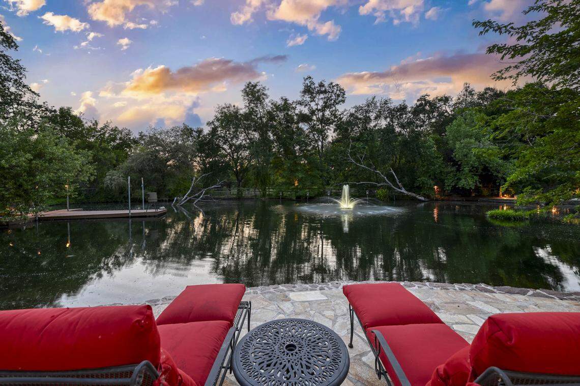 A tranquil spring-fed pond with a private dock and beach brings water’s-edge serenity to the estate, 9345 King Road, Loomis.