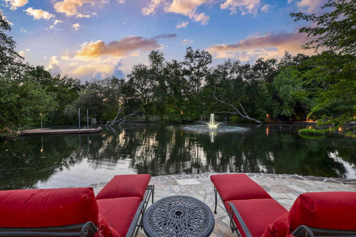 A tranquil spring-fed pond with a private dock and beach brings water’s-edge serenity to the estate, 9345 King Road, Loomis.
