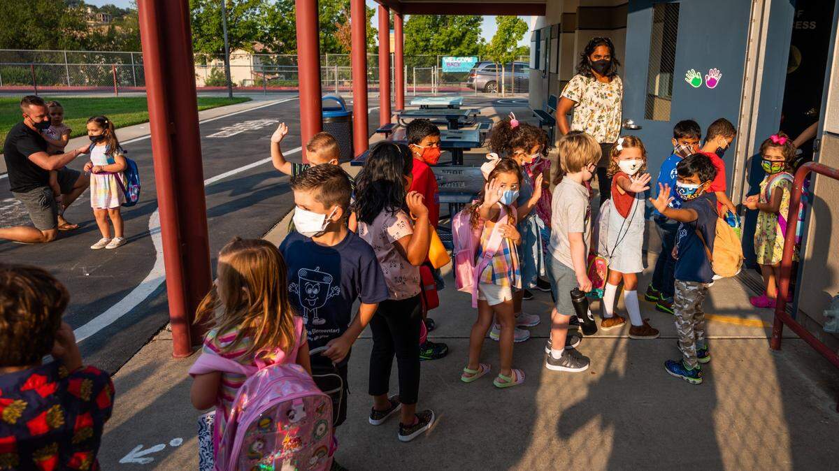 Kindergarteners start their first day of school at Empire Oaks Elementary School in Folsom on Wednesday, Aug. 11, 2021. After a year of distance learning due to COVID-19 related closures, students were introduced to full day, five days a week, in-person instruction in the Folsom Cordova School Unified School District on Wednesday morning. “We are following the current guidelines — which are masks indoors and, you know, we will eat lunch outside as much as possible. But when we are inside for lunch, we will practice some safety measures like distancing,” said Principal Sara Parenzin of Empire Oaks Elementary School.