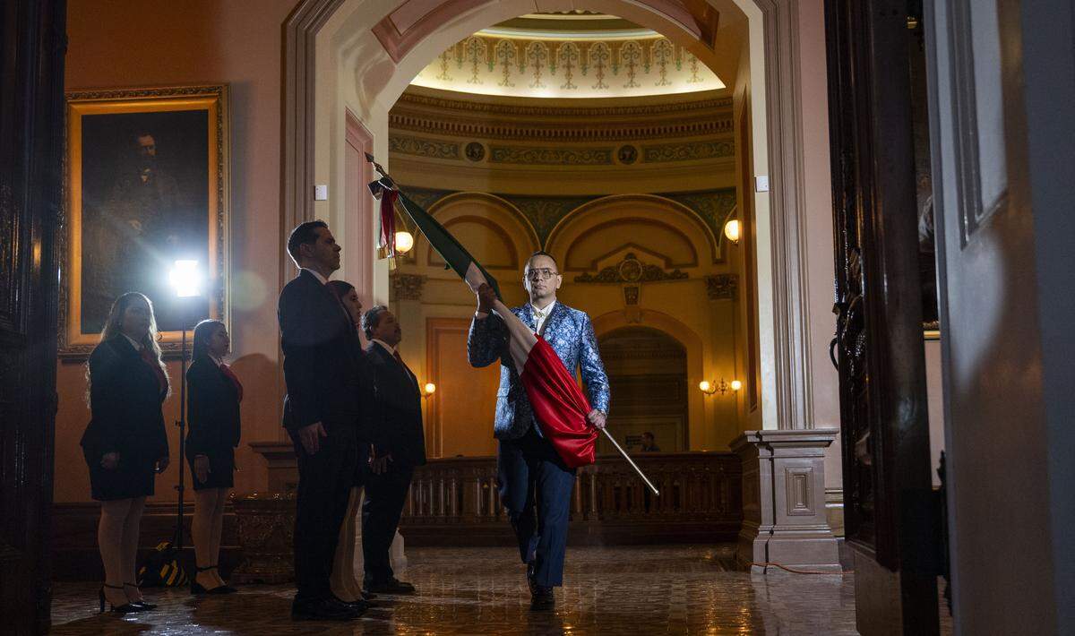 Christian Tonatiuh González, consul general of Mexico in Sacramento, carries the Mexican flag during a Mexican Independence Day ceremony at the state Capitol on Monday.