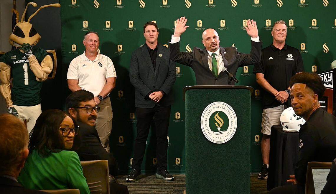 Sacramento State athletic director Mark Orr, center, excitedly announces Thursday, Sept. 26, 2024, plans for a new 25,000-seat, multi-use football stadium.