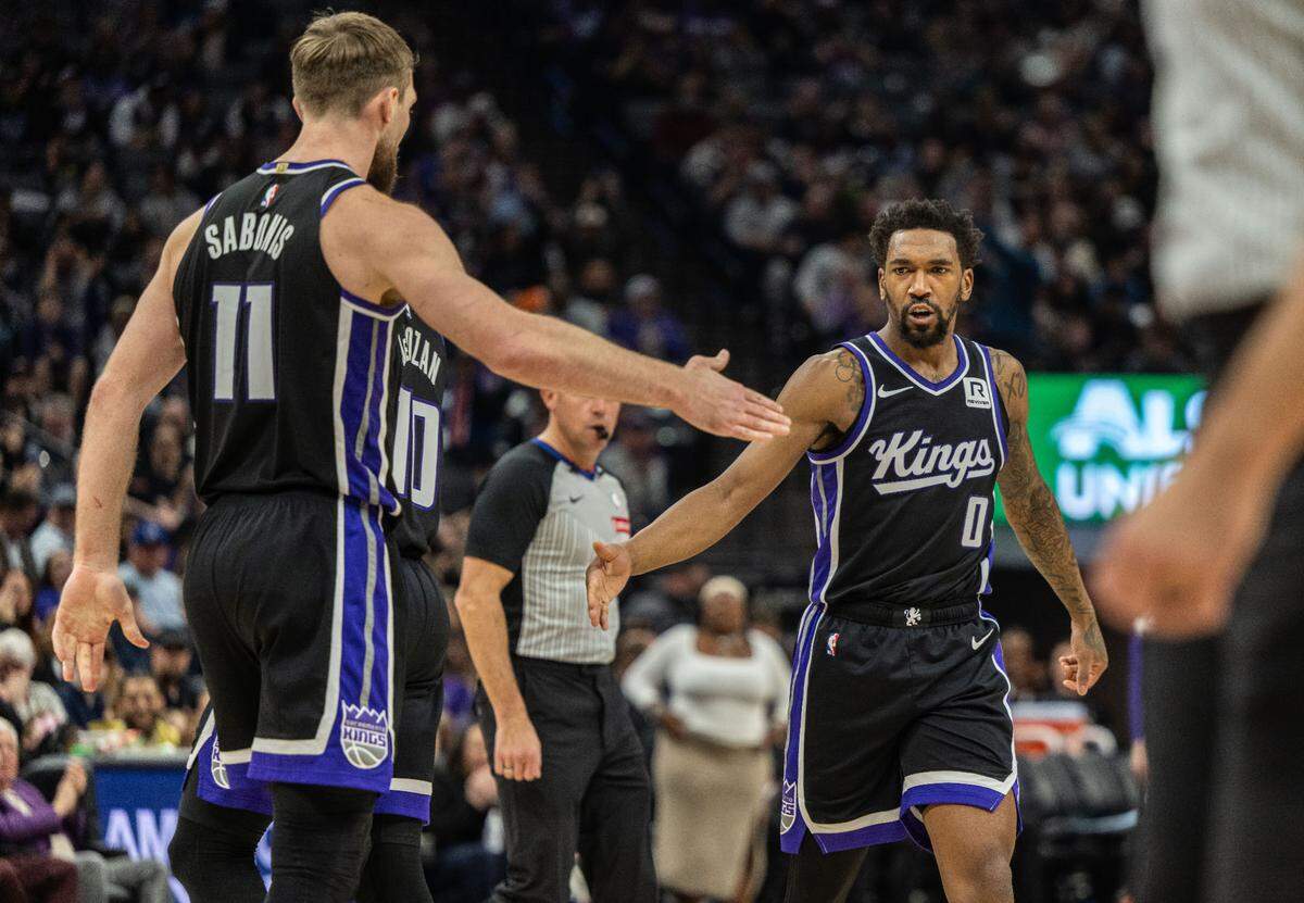 Sacramento Kings center Domantas Sabonis (11) celebrates a three point play with teammate guard Malik Monk (0)during an NBA game on Thursday, Jan. 16, 2025 at Golden 1 Center.
