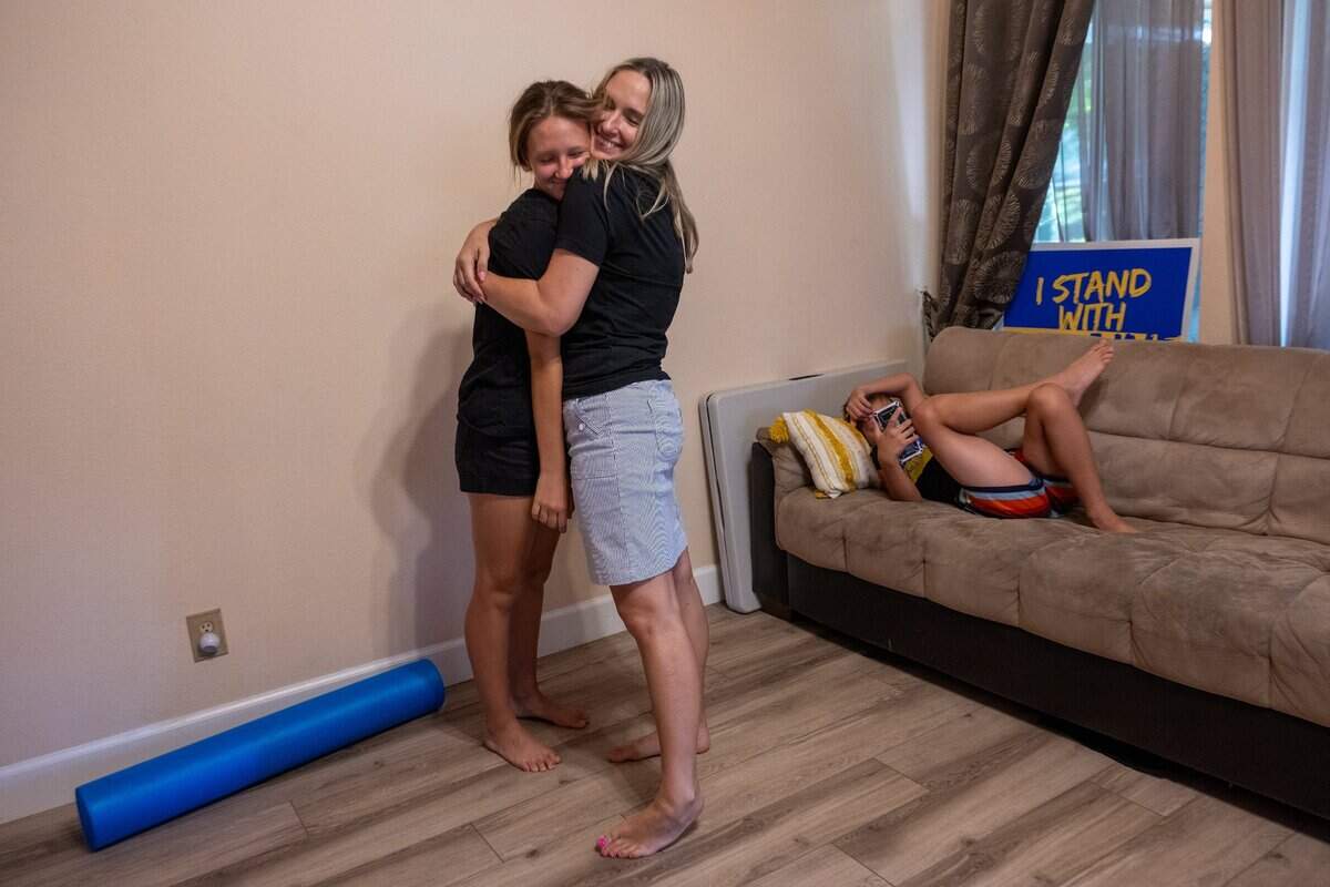 Svitlana Iotko hugs her daughter Anastasia, 12, who suffers from scoliosis after her physical therapy exercises at home in Fair Oaks on Friday, July 21. “My daughter has scoliosis and the doctor at Elica was so nice that she referred us to physical therapy so we are pretty happy to have these people as friends,” said Iotko.