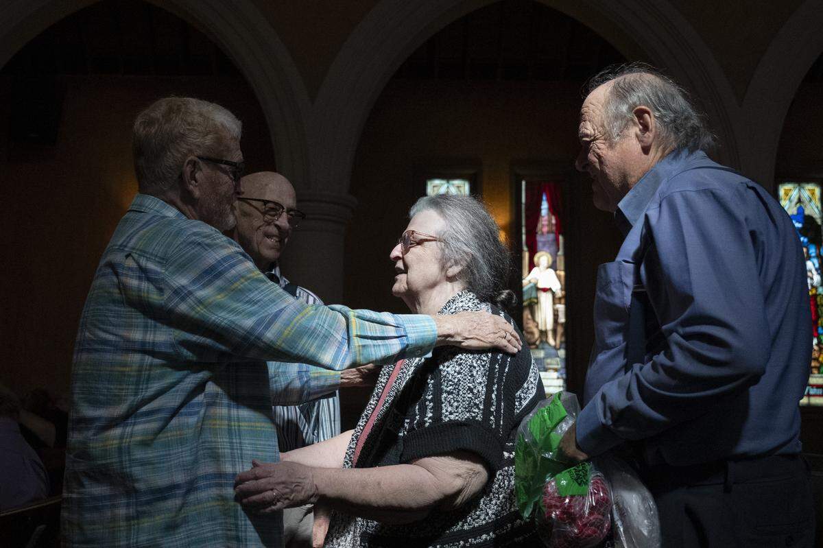 Barbetta Laurelle greets Raymond Graetz and Joseph Lenihan before the final service of Pioneer Congregational United Church of Christ at their church on L Street in Sacramento on Sunday, May 31, 2026.