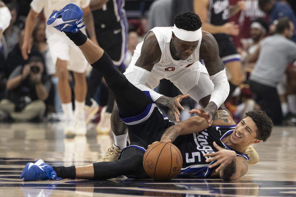Sacramento Kings guard Nique Clifford (5) and Cleveland Cavaliers guard Dennis Schroder (8) fight for the ball during a game at Golden 1 Center in Sacramento on Saturday, Feb. 7, 2026.