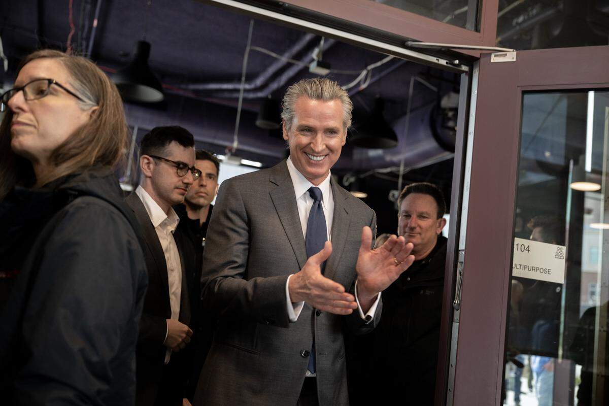 Gov. Gavin Newsom enters an auxiliary room to meet with local media at San Quentin Learning Center on Friday.