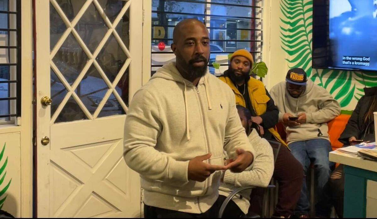 Chris Lodgson, lead organizer of Coalition for a Just and Equitable California, explains the state of reparations to a group of community members at Drip, a Black-owned coffee shop in midtown Sacramento, on Saturday.