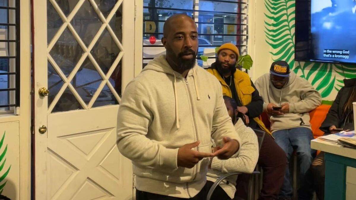 Chris Lodgson, lead organizer of Coalition for a Just and Equitable California, explains the state of reparations to a group of community members at Drip, a Black-owned coffee shop in midtown Sacramento, on Dec. 10, 2022.