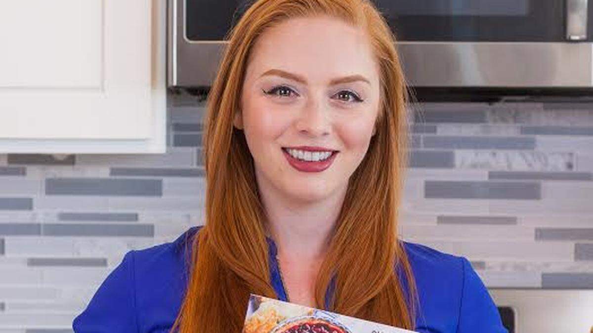 Author Tatyana Nesteruk holds her cookbook, “Beyond Borscht: Old-World Recipes from Eastern Europe: Ukraine, Russia, Poland & More.”