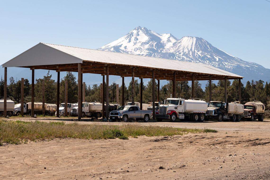Water trucks on Stephen Griset’s property in the shadow of Mount Shasta sit unused May 13, 2021, after local authorities passed a law requiring a permit to transport water over 100 gallons on certain local roads, including nearby County Road A-12. District Attorney Kirk Andrus said the ordinance, in combination with prohibiting local well owners from selling water to marijuana growers, were aimed at stopping the illegal cultivation of marijuana.