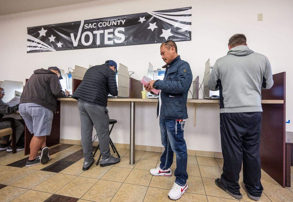 Sacramento resident Chinh Phan places his ballot in an envelope after voting at the Sacramento County Voter Registration and Elections office on Tuesday, Nov. 5, 2024.