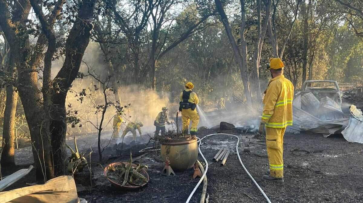 Firefighters working on extinguishing a wildfire that burned burned nearly 70 acres on Tuesday May 24, 2022, near Davis.