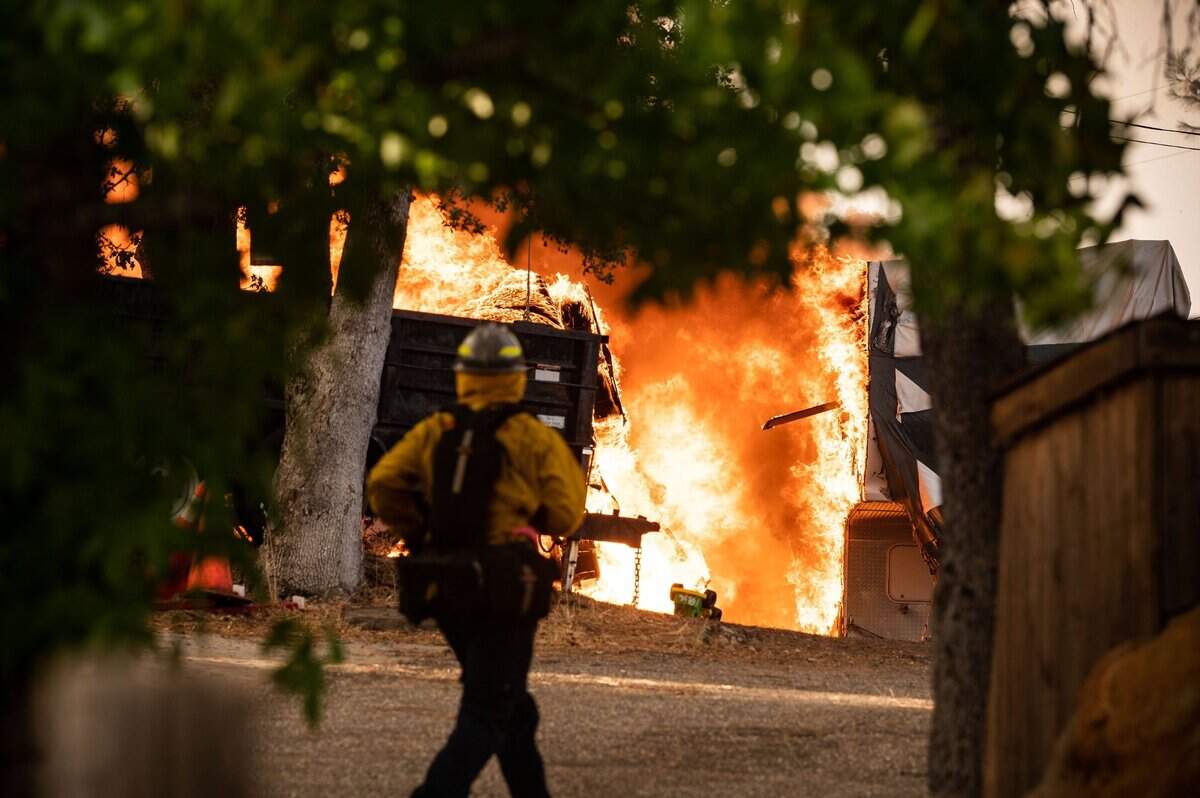 The River Fire burns at a business and property on the 16000 block of Mount Olive Road on Wednesday, Aug. 4, 2021, in Nevada County.