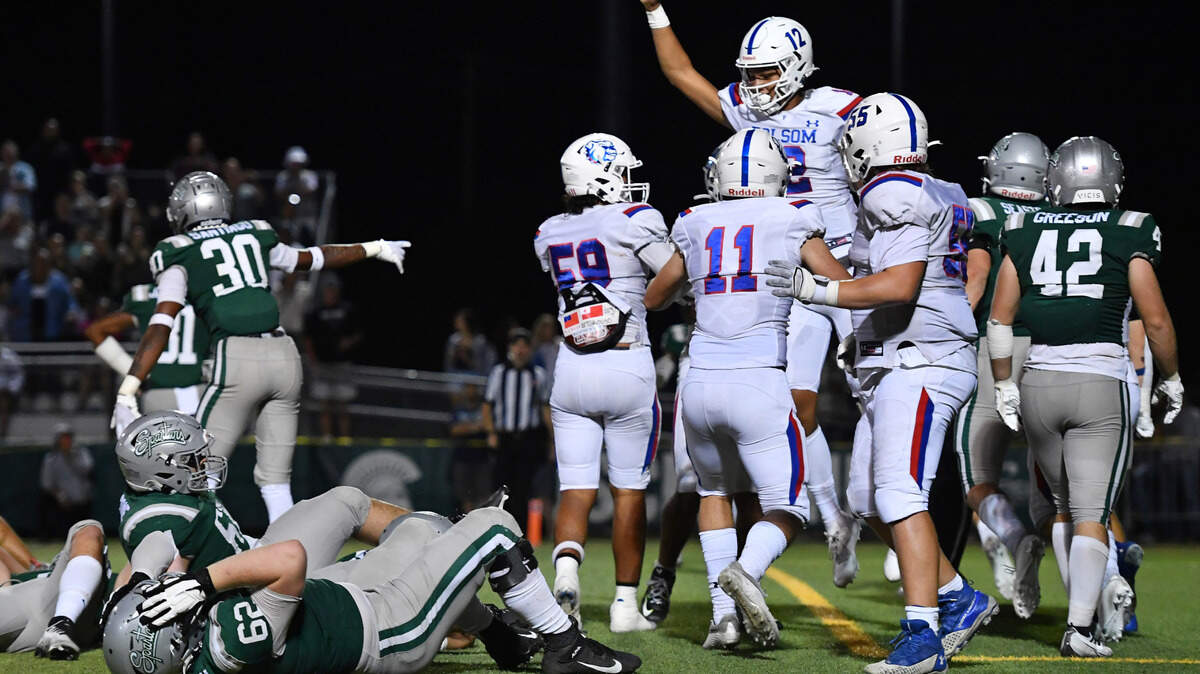 De La Salle’s Derek Thompson (62) reacts on the ground as Folsom quarterback Austin Mack (12) celebrates his two-yard touchdown run during the fourth quarter of their game at De La Salle High School in Concord on Friday, Sept. 23, 2022. Folsom defeated De La Salle 24-20.