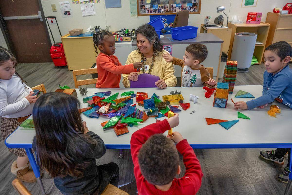 Teacher Dometila Casillas helps Rylann Collier, 3, left, and Emiliano Soto, 4, right, as students participate in a building project during a Head Start preschool program in Sacramento on Wednesday. “My favorite time is free choice because they are able to choose what they want to do, and I can foster learning through that,” said Casillas.