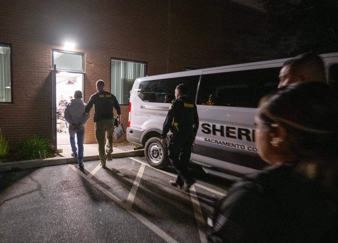 Sacramento Sheriff’s deputy Eilers escorts a man arrested for propositioning a female deputy posing as prostitute on Watt Avenue in Sacramento on Friday.