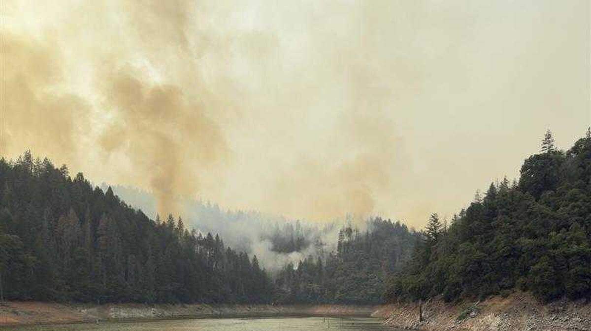 Smoke rises from the Green Fire in Shasta County on July 18. The fire was 95% contained by Friday, officials said.