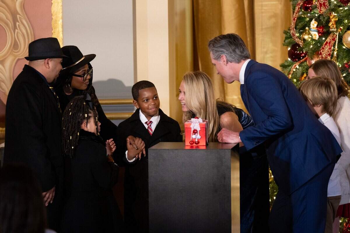 Gov. Gavin Newsom and First Partner Jennifer Siebel Newsom talk with Carter Morris, 9, from Merced after lighting the 93rd annual California Capitol tree lighting ceremony at the state Capitol on Wednesday, Dec. 11, 2024. Carter is joined at left by his parents Lynne and Karl Morris and sister Samira.