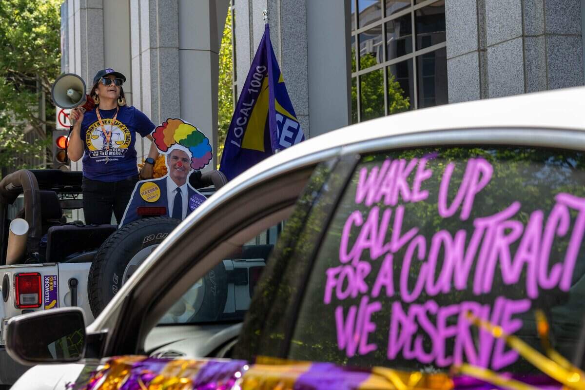 Anica Walls, president of SEIU Local 1000, leads a caravan of union members and vehicles protesting return-to-office requirements in Sacramento on Wednesday, June 10, 2026. SEIU Local 1000 members rallied to oppose state return-to-office policies affecting California government workers.
