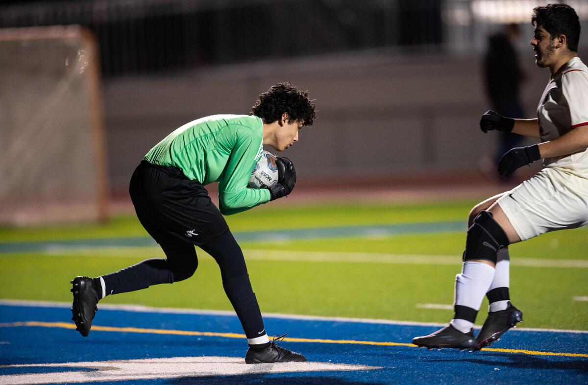 Vista del Lago goalkeeper Jacob Granados scoops up the ball during a challenge by Galt’s Alan Lopez during the second half of the high school boys soccer Sac-Joaquin Section playoff game Tuesday, Feb. 15, 2022, at Vista del Lago High School in Folsom. Vista del Lago beat Galt 6-1.