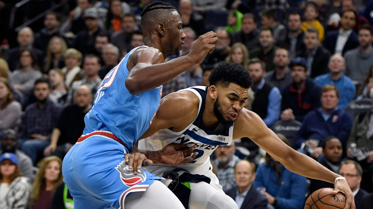 Sacramento Kings forward Harry Giles (20) guards Minnesota Timberwolves center Karl-Anthony Towns (32) in the second quarter Dec. 17 in Minneapolis. Towns was expected to play against the Kings on Monday night, Feb. 25, 2019, after missing the first two games of his NBA career following a car accident.